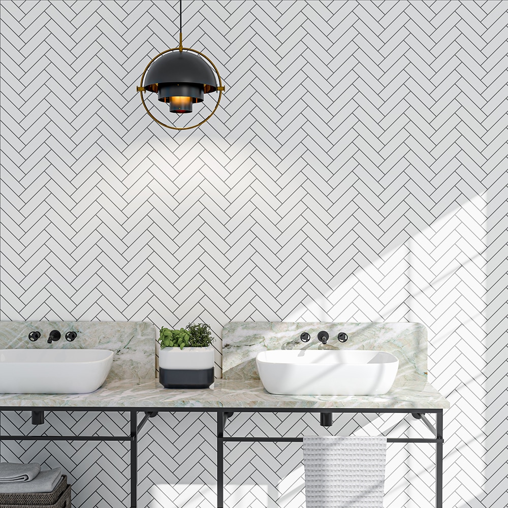 White herringbone ceramic bathroom wall tiles with bold black grout lines.