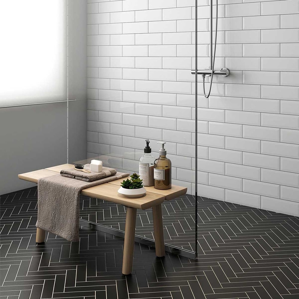 White subway ceramic shower wall tiles with dark grout lines.