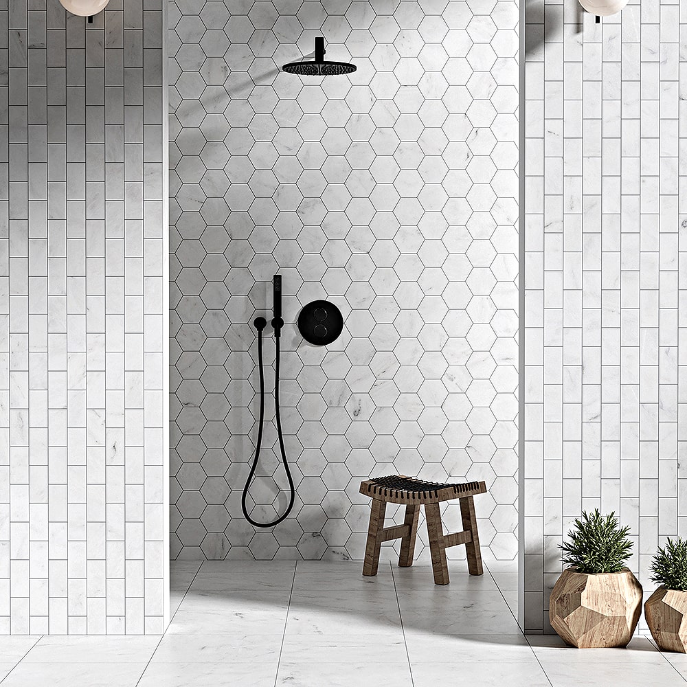 Modern walk-in shower featuring white marble hexagon tiles on the back wall and vertical white marble subway tiles on the side walls.