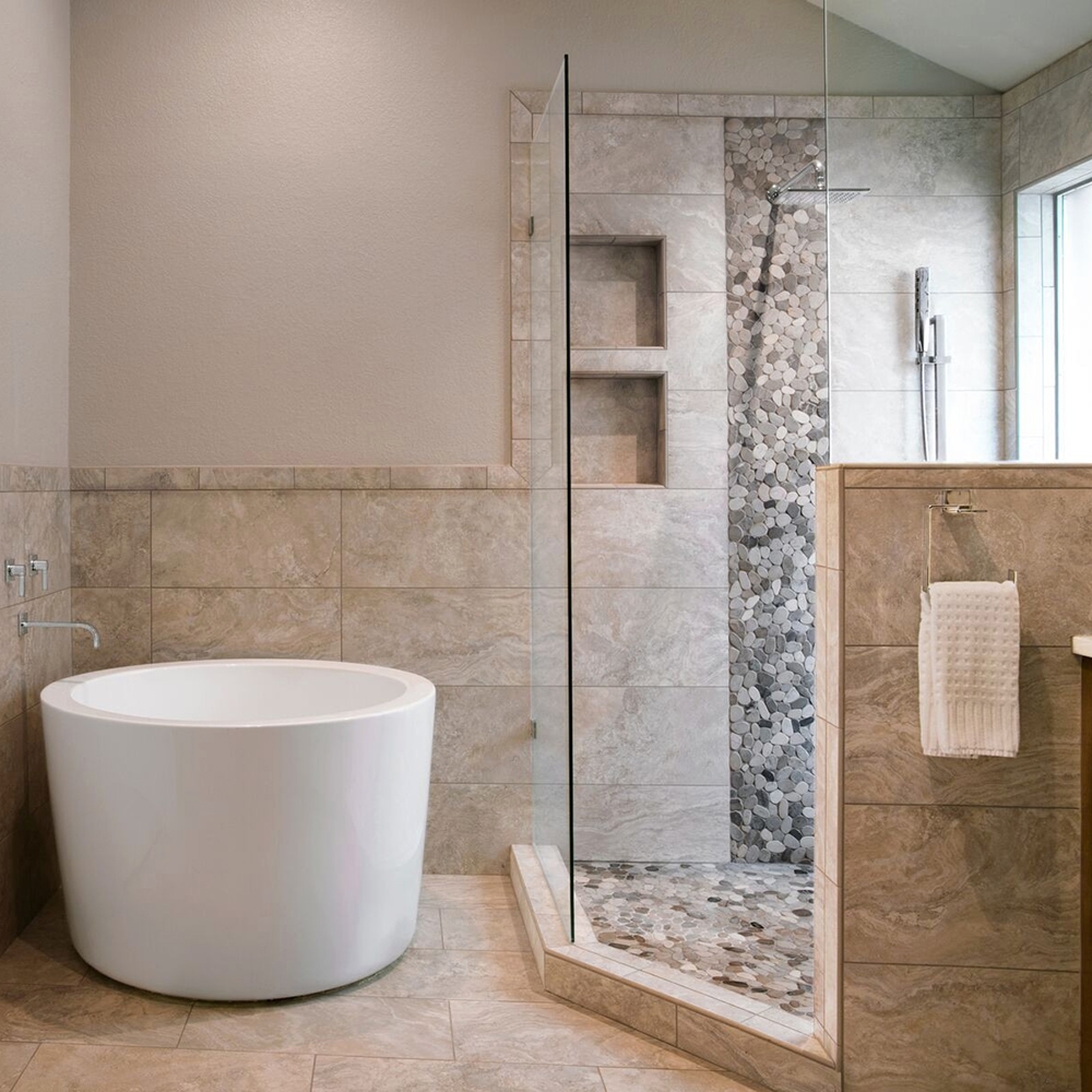 Luxury master bathroom featuring white marble tile walls.