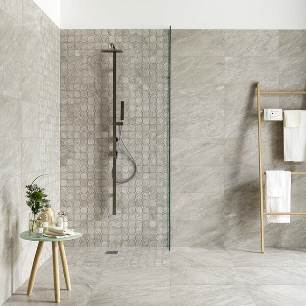 Large walk-in shower design using durable large format marble look porcelain tiles for seamless walls.
